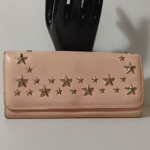 Jimmy Choo Nino ballerina pink leather wallet featuring star studs.
